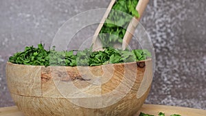 Dry parsley spice with wooden spoon in wooden bowl. Homegrown herbs and spices for cooking. Fresh dried aromatic natural