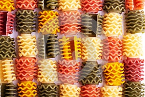 Dry pasta Fusilli tricolore full frame. Close-up