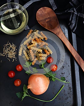 Dry pasta, onion tomatoes parsley and herbs