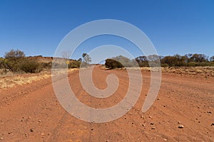 dry path of sand in the australian outback ends in the desert