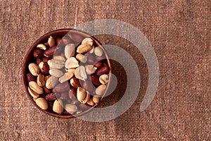 dry peanuts background. close up dry peanuts in clay bowl. Space for pext. Copyspace