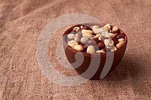 dry peanuts background. close up dry peanuts in clay bowl. Space for pext. Copyspace