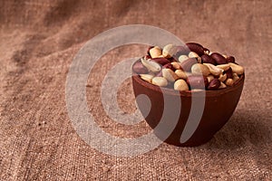 dry peanuts background. close up dry peanuts in clay bowl. Space for pext. Copyspace