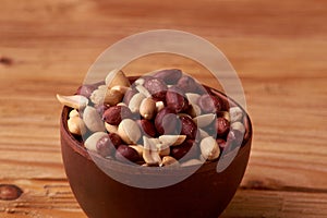 dry peanuts background. close up dry peanuts in clay bowl. Space for pext. Copyspace