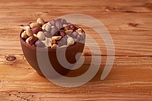 dry peanuts background. close up dry peanuts in clay bowl. Space for pext. Copyspace