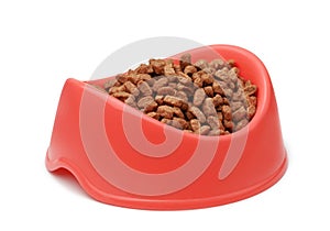 Dry pet feed in red plastic bowl