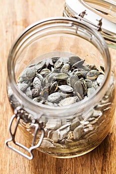 Dry pumpkin seeds in a glass jar