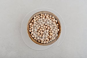 Dry raw organic chickpeas in wooden bowl