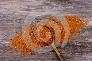 Dry Red clay mask for face and body in a wooden spoon.  on old wooden background