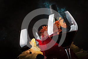 Dry Red Wine in big wine glass, autumn still life with leaves, wine tasting concept, rustic style, selective focus