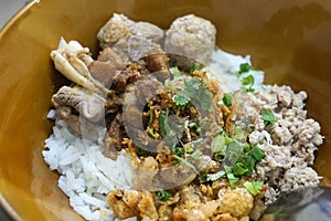 Dry rice congee with meatballs, meats