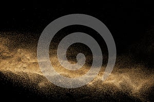Dry river sand explosion. Golden colored sand splashing. photo