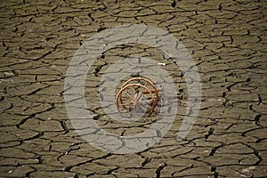 Dry riverbed with cracked mud in hot summer