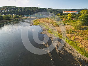 Dry riverbed of river Elbe in Decin, Czech Republic. Castle above old railway bridge
