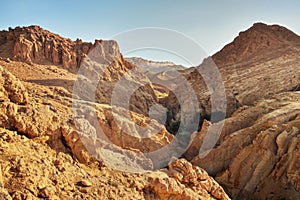 Dry rocks in desert, lit by midday sun. Chebika oasis