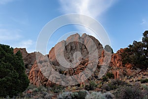 Dry rocky desert mountain landscape with trees. Sunny Sunset Sky