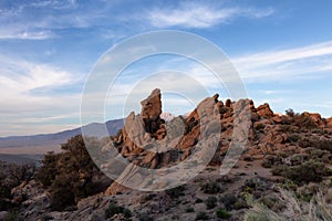 Dry rocky desert mountain landscape with trees. Sunny Sunset Sky