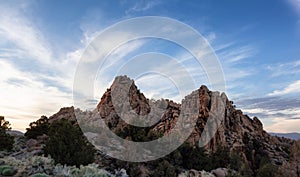 Dry rocky desert mountain landscape with trees. Sunny Sunset Sky