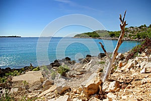 Dry rocky land on the coast of the turquoise sea