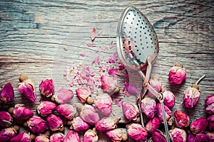 Dry rose buds tea and tea infuser.