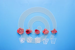 Rose placed on the desk in blue background