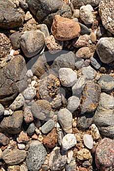 Dry round stones on beach background