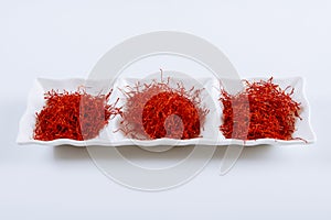Dry Saffron Spice on a white Plate on white Background photo