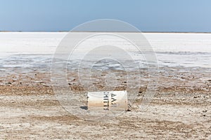 Dry salt lake with a fallen container