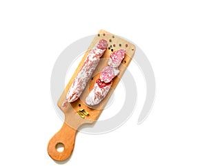 Dry sausage fuet in natural casing whole and sliced on white background. Sin Gluten. Tradicion mediterranea. photo