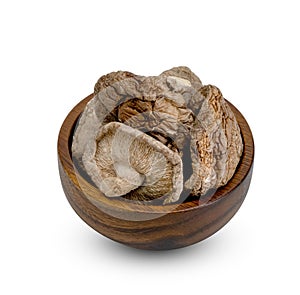 Dry shiitake mushrooms in wooden bowl isolated on white background ,include clipping path