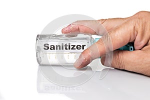 Dry skin finger with bottle of hand sanitizer. Sanitizer causes dryness with frequent use