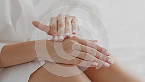 Dry Skin Treatment. Unrecognizable Lady Applying Moisturizing Cream On Hand At Home