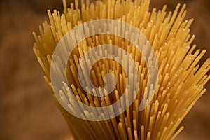 Dry spaghetti on wooden background noodle