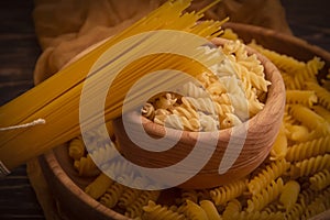 Dry spaghetti on wooden background noodle food