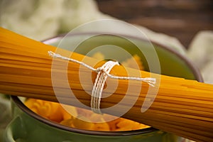 Dry spaghetti on wooden background nutrition uncooked