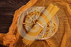 Dry spaghetti on wooden background various cuisine pasta nutrition uncooked