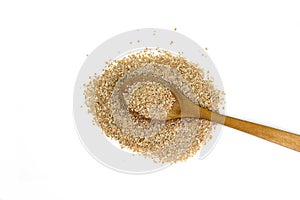 Dry spelt bran pile in a wooden spoon isolated