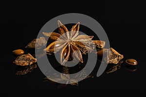 Dry star anise isolated on black glass