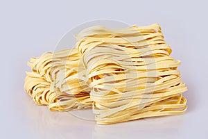Dry thick rolled noodles square shape. Capelli d`angelo, Angel`s hair - pasta. photo