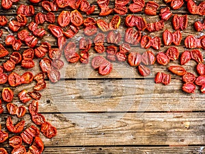 Dry tomatoes on a wooden background