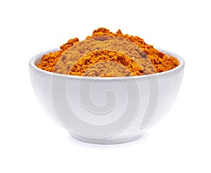 Dry turmeric powder in white bowl isolated on white background