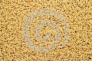 Dry uncooked cavatappi pasta texture background
