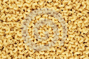 Dry uncooked cellentani pasta texture background