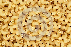 Dry uncooked cellentani pasta texture background