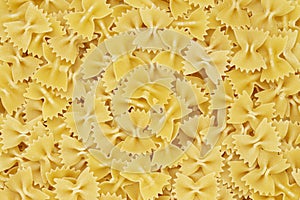 Dry uncooked farfalle pasta as a background. Flat lay