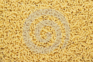 Dry uncooked rotini texture background