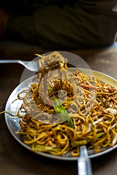 Dry vegetable chow mein noodles served in plate in himalayas