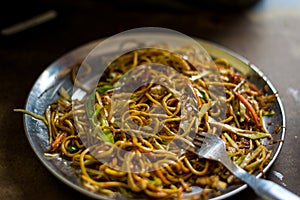 Dry vegetable chow mein noodles served in plate in himalayas