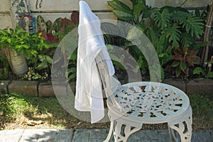 Dry wet white towel on white outdoor chair