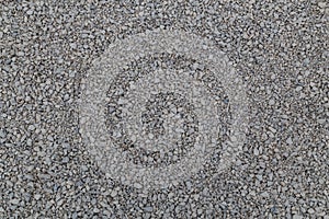 Dry white limestone ballast flat full frame background. Small gray dusty broken macadam stones texture.